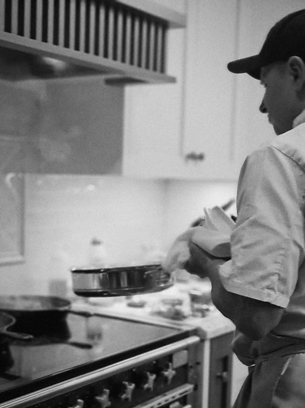 Boyan tossing a pan at the stove