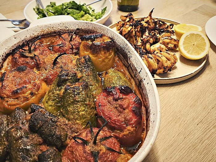 Baked gemista and dolmas with grilled squid and lemon