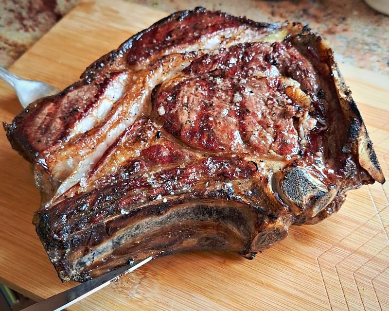 Seared bone-in rib steak with flaky salt